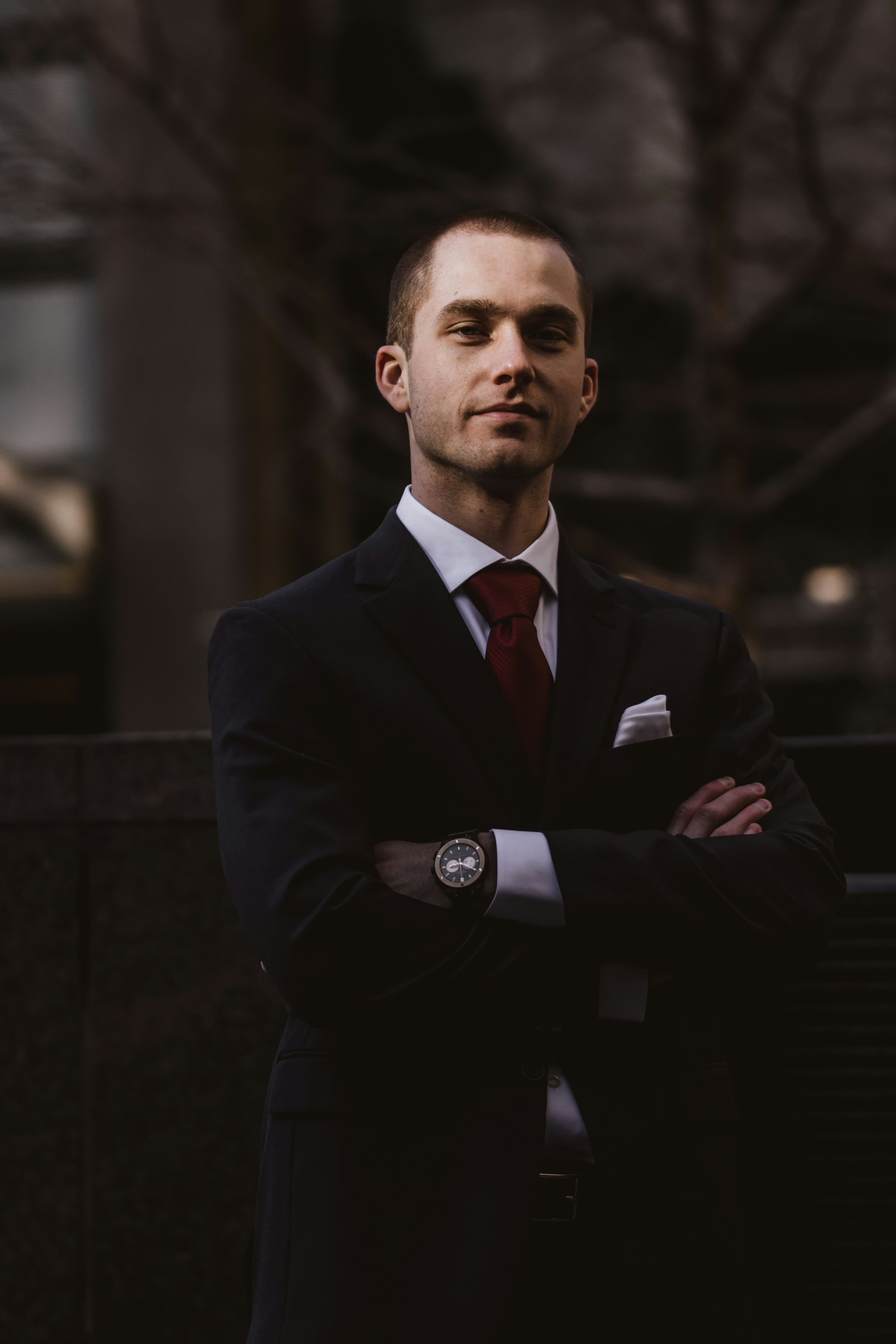 Confident man in a suit with arms crossed