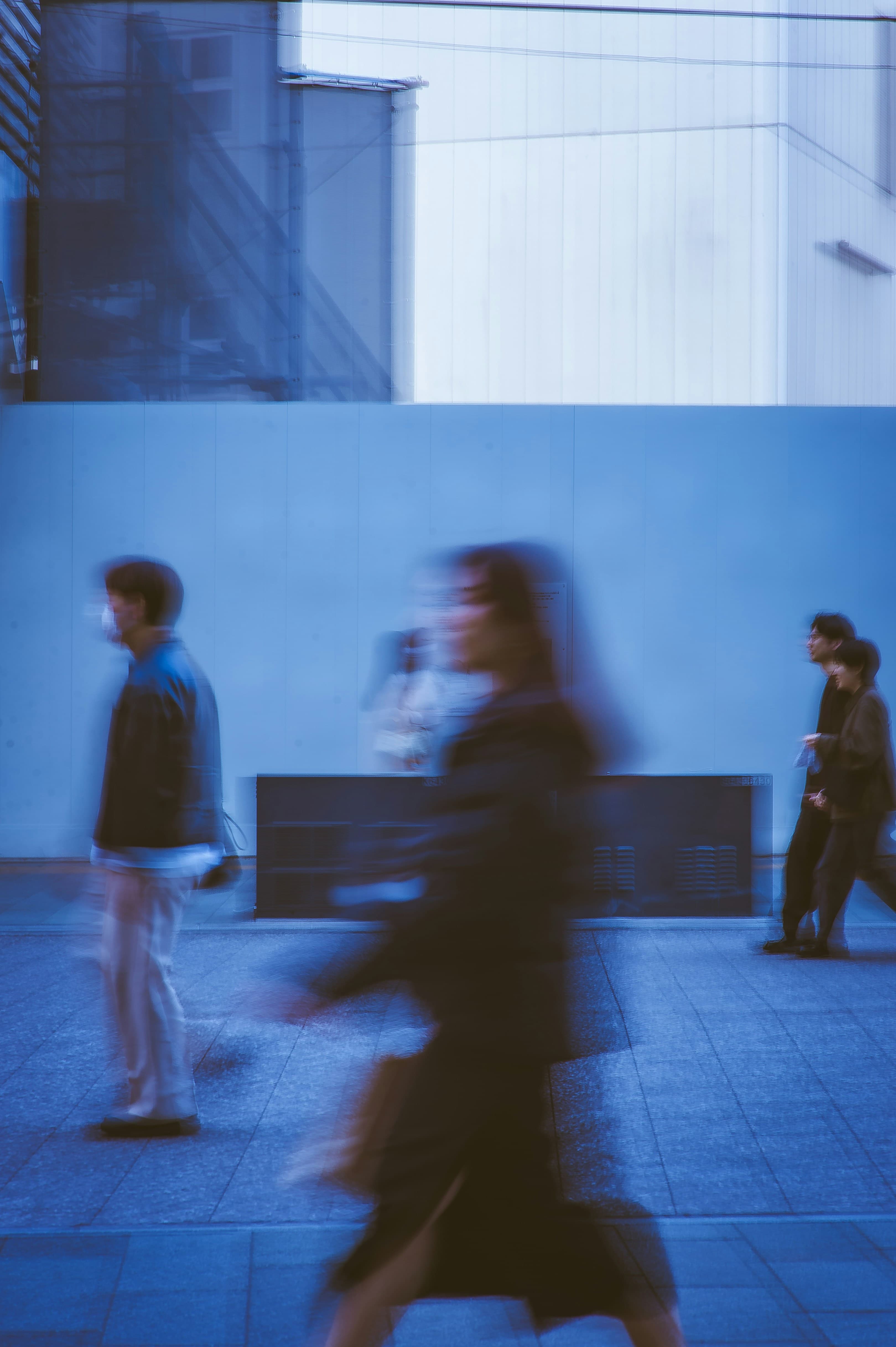 Motion blur of professionals walking in a city at night
